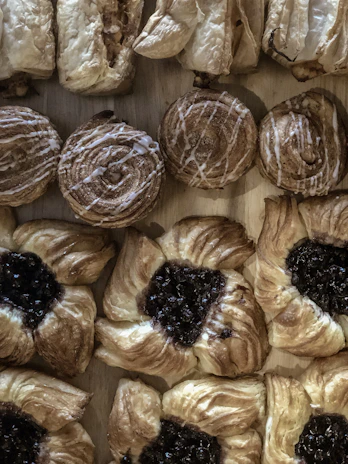A variety of pastry strips in different shapes and sizes neatly arranged on a wooden board.
