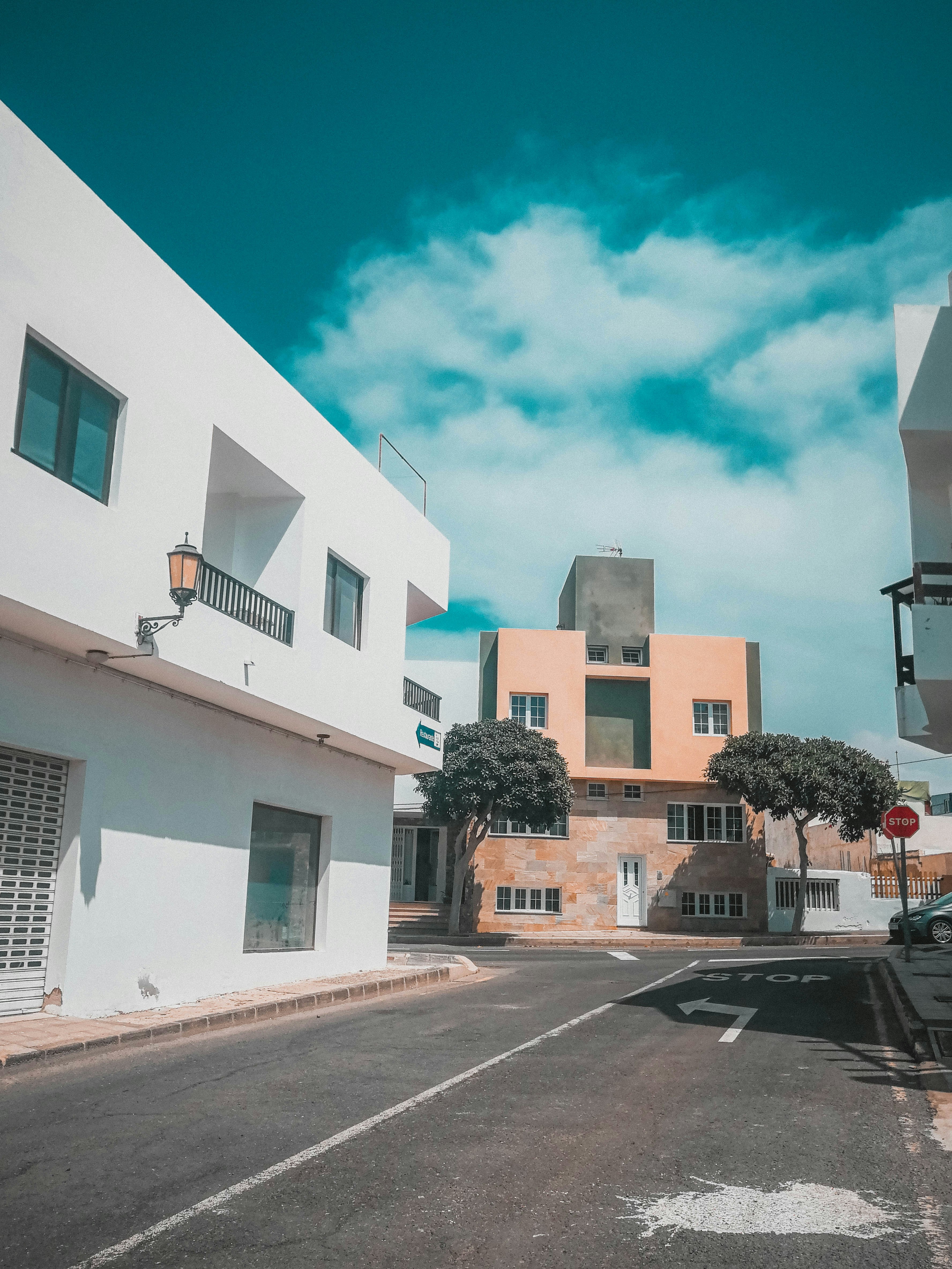 empty road near white and brown buildings