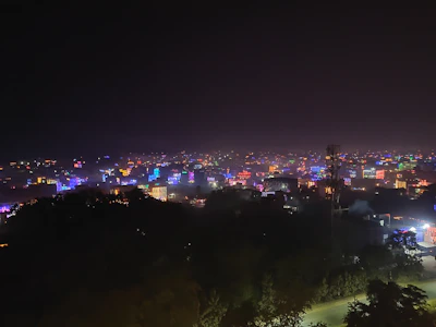 A nighttime cityscape of a Bahia town lit up with vibrant colors reflecting community spirit and energy.
