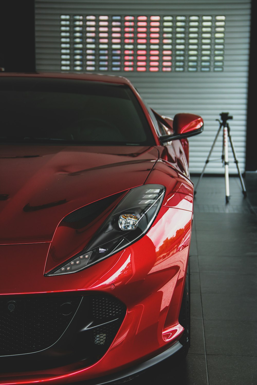 red car parked inside garage