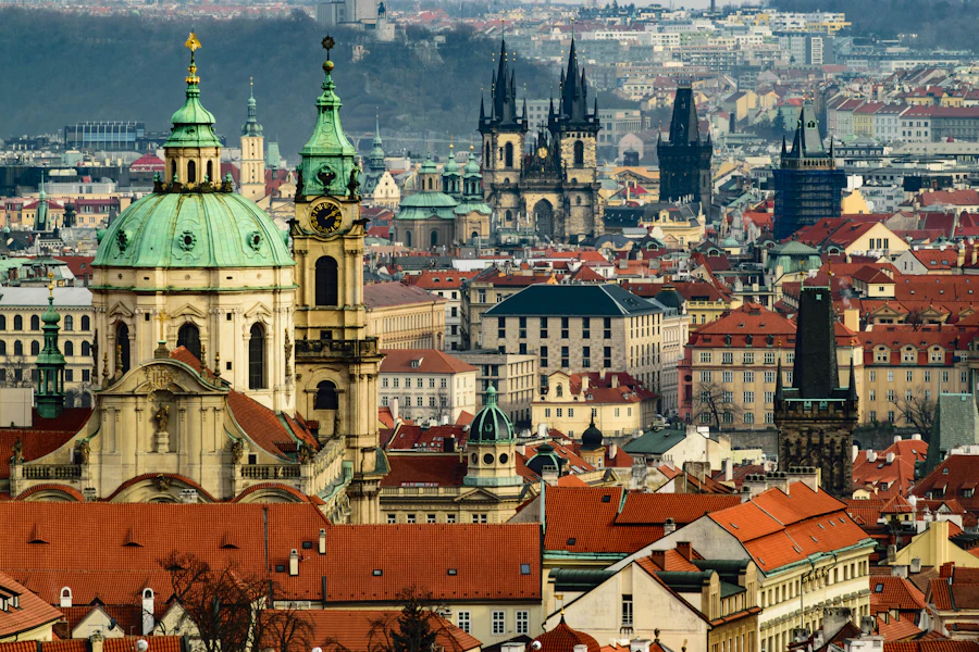 Prague old town skyline with castle and river at golden hour