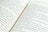 A close-up view of an open book displaying two pages. The text is in English, and the pages are slightly curved, suggesting the book is lying flat. The focus is on the middle section where the pages meet, and the text is clearly legible.