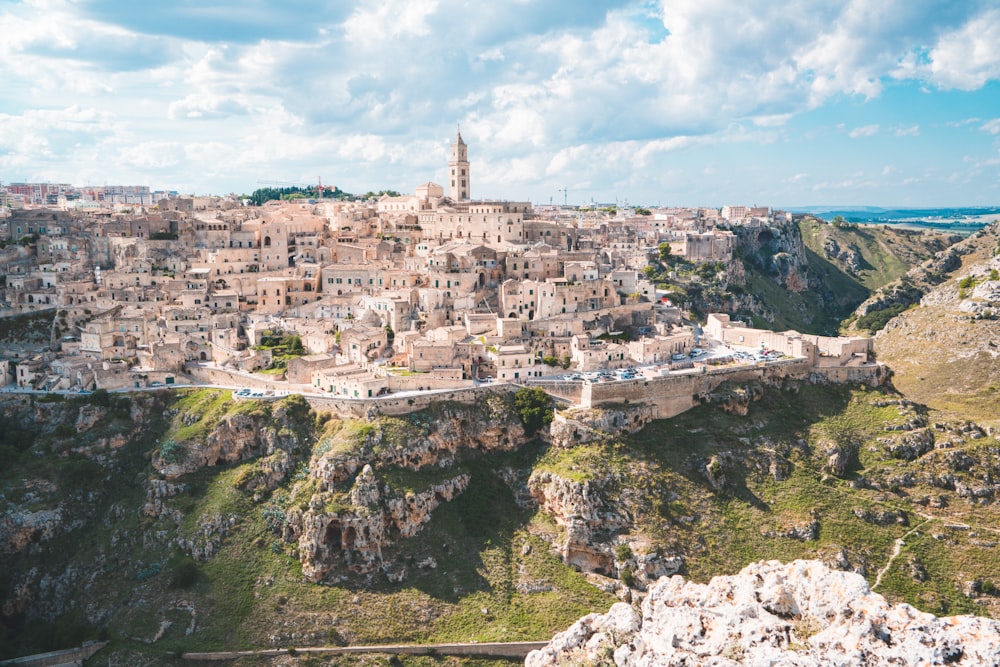 buildings atop hill during daytime