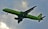 A green commercial airplane with the logo S7 on its body and tail is flying against a cloudy sky. The aircraft is in mid-flight with its landing gear extended, indicating either a landing or takeoff phase.