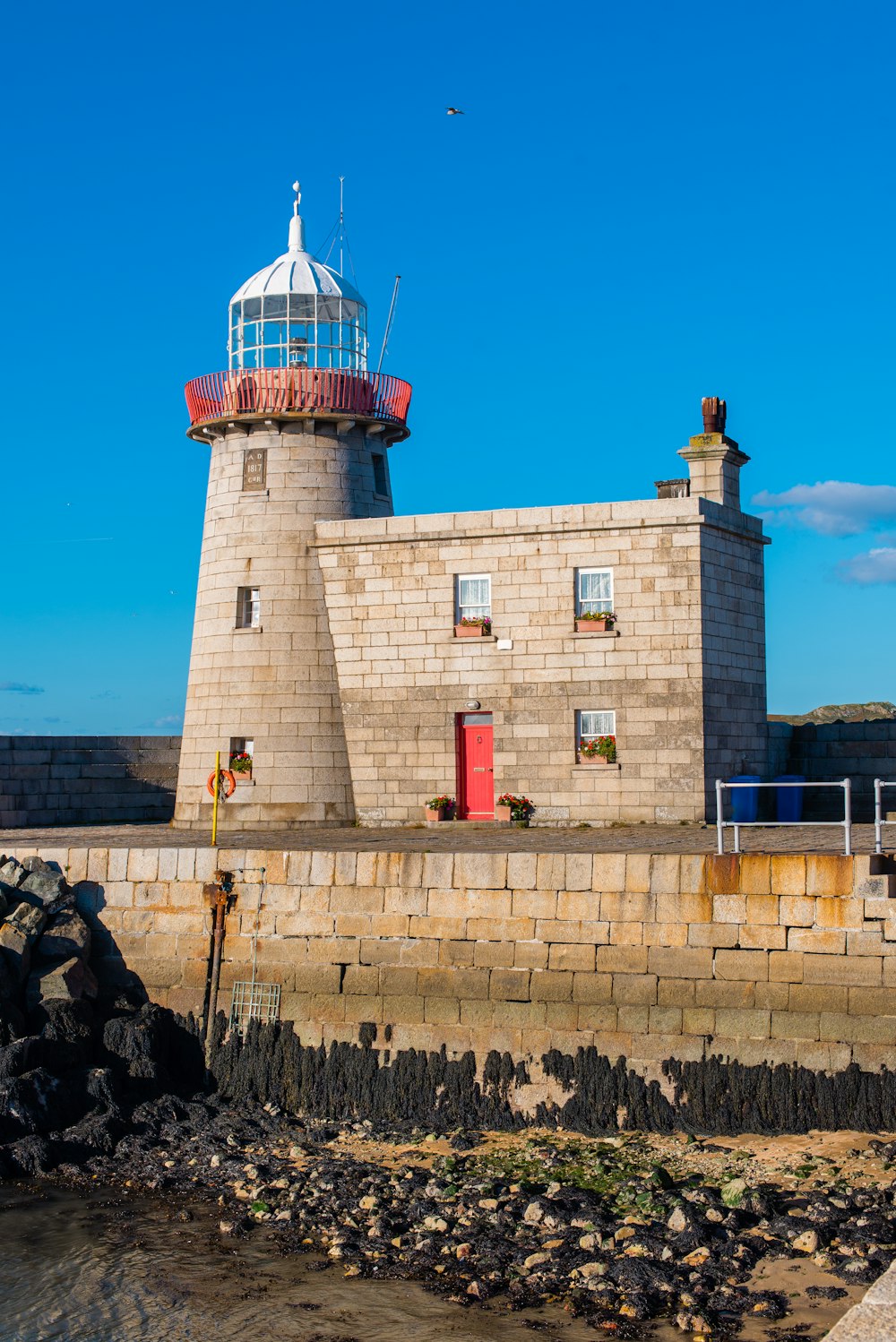 brown brick building with lighthouse