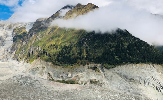 mountains surrounded with water during daytime in Luding China