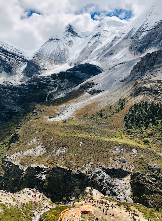 green mountains during daytime in Daocheng China