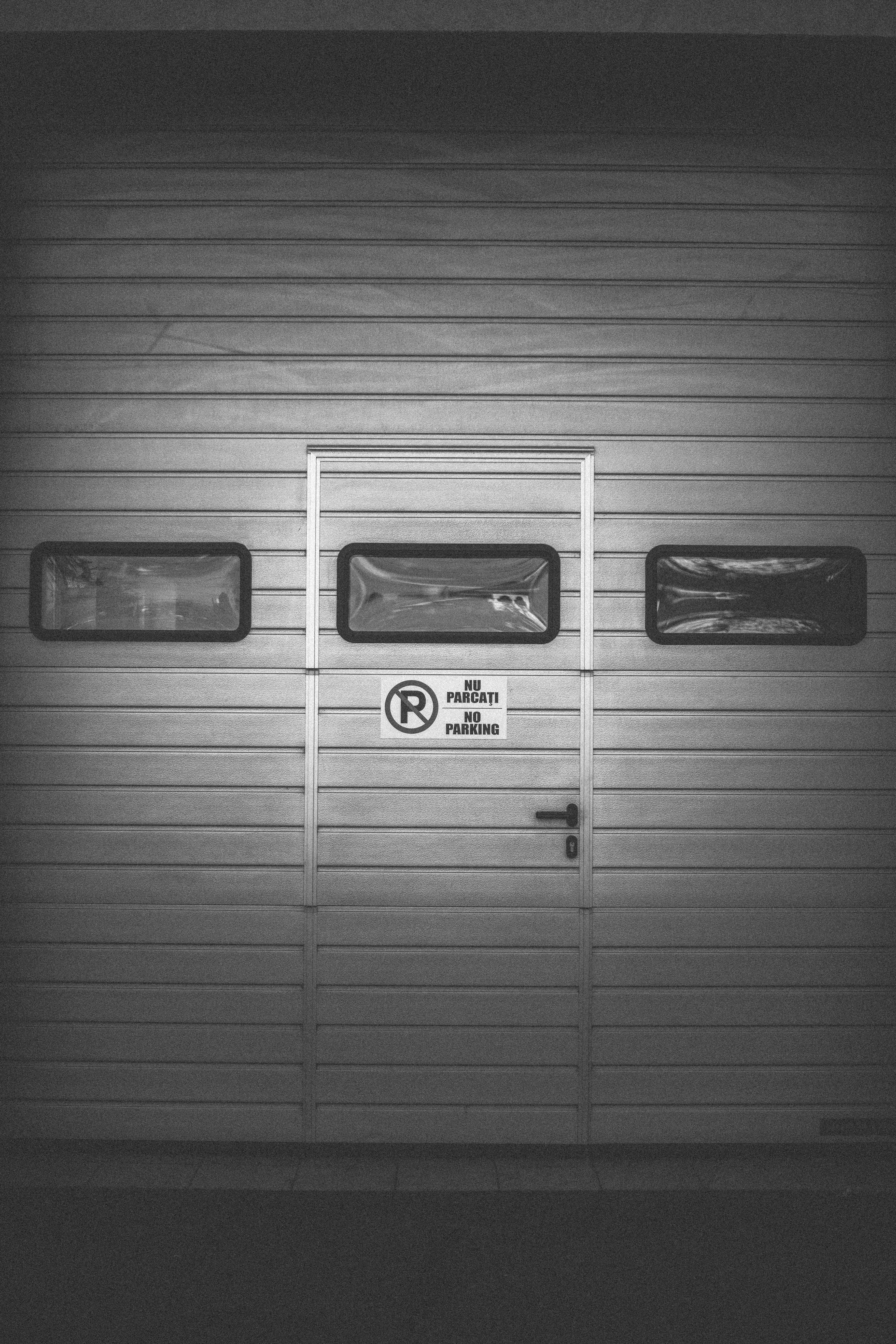 a black and white photo of a garage door
