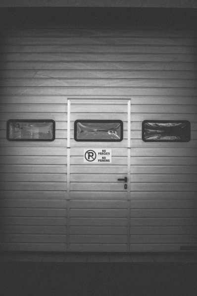 a black and white photo of a garage door