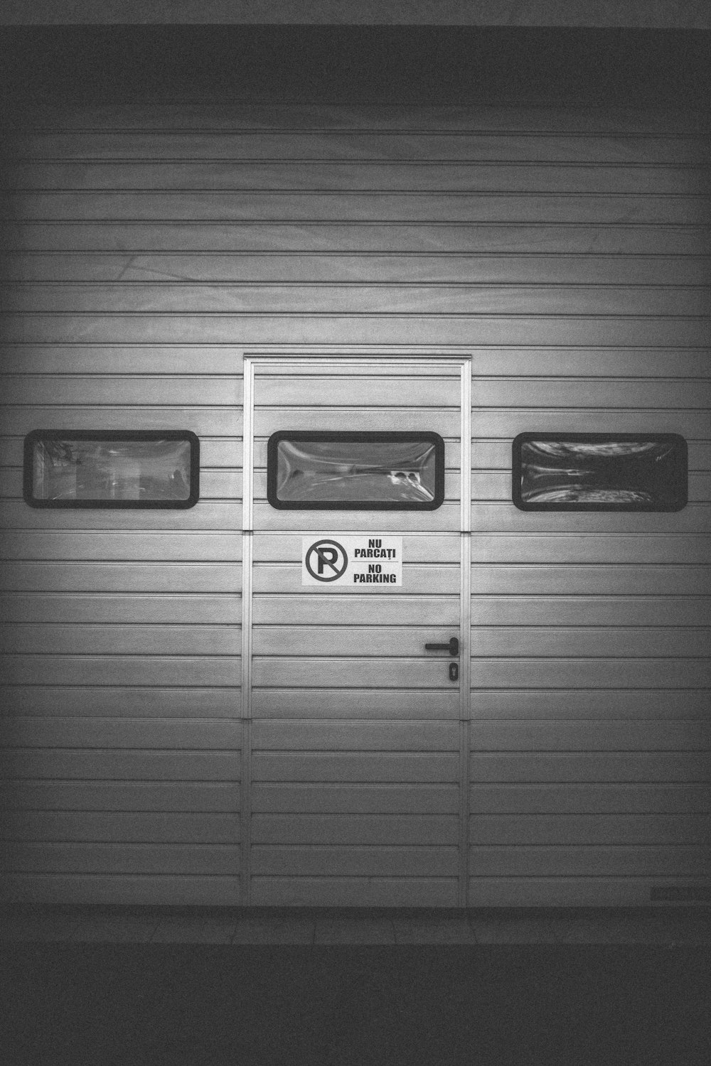 a black and white photo of a garage door