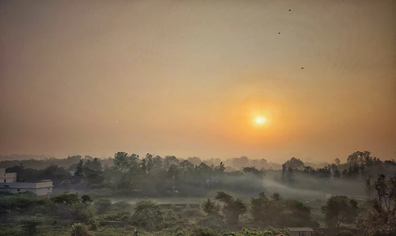 A serene sunrise over a quiet village symbolizing hope and new beginnings.