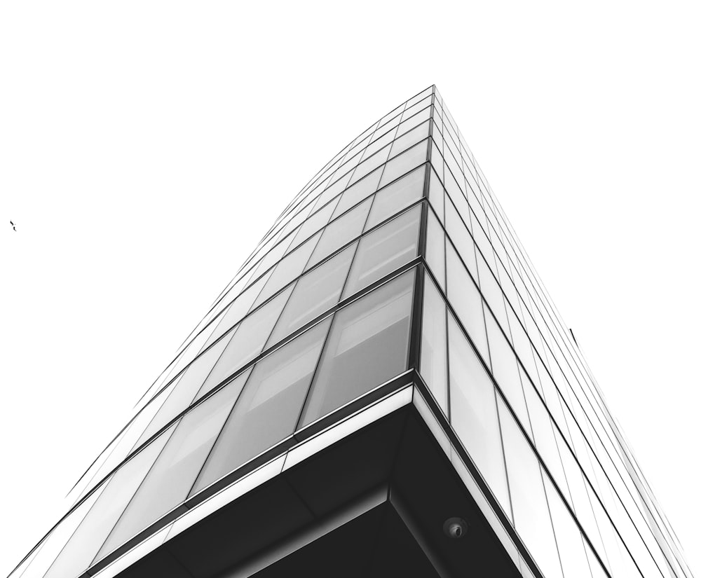 low angle photography of glass building under cloudy sky