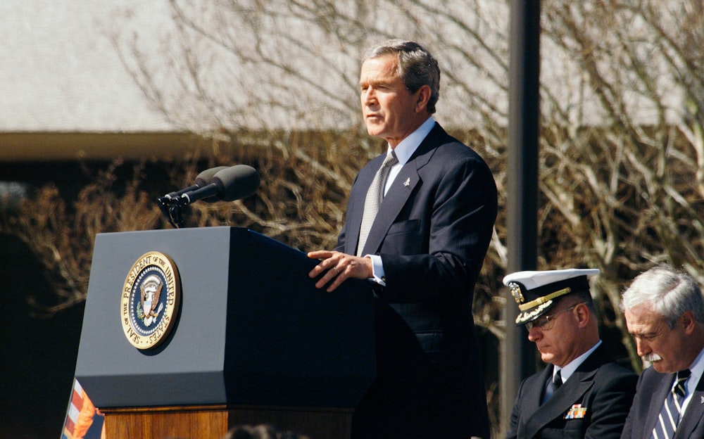 George W. Bush standing on lectern during daytime