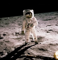 astronaut standing on gray sand