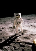 astronaut standing on gray sand