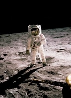 astronaut standing on gray sand