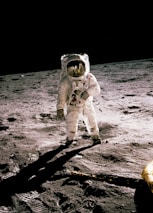 astronaut standing on gray sand