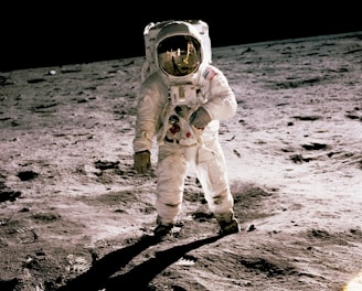 astronaut standing on gray sand