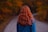 woman in denim jacket walking on empty road