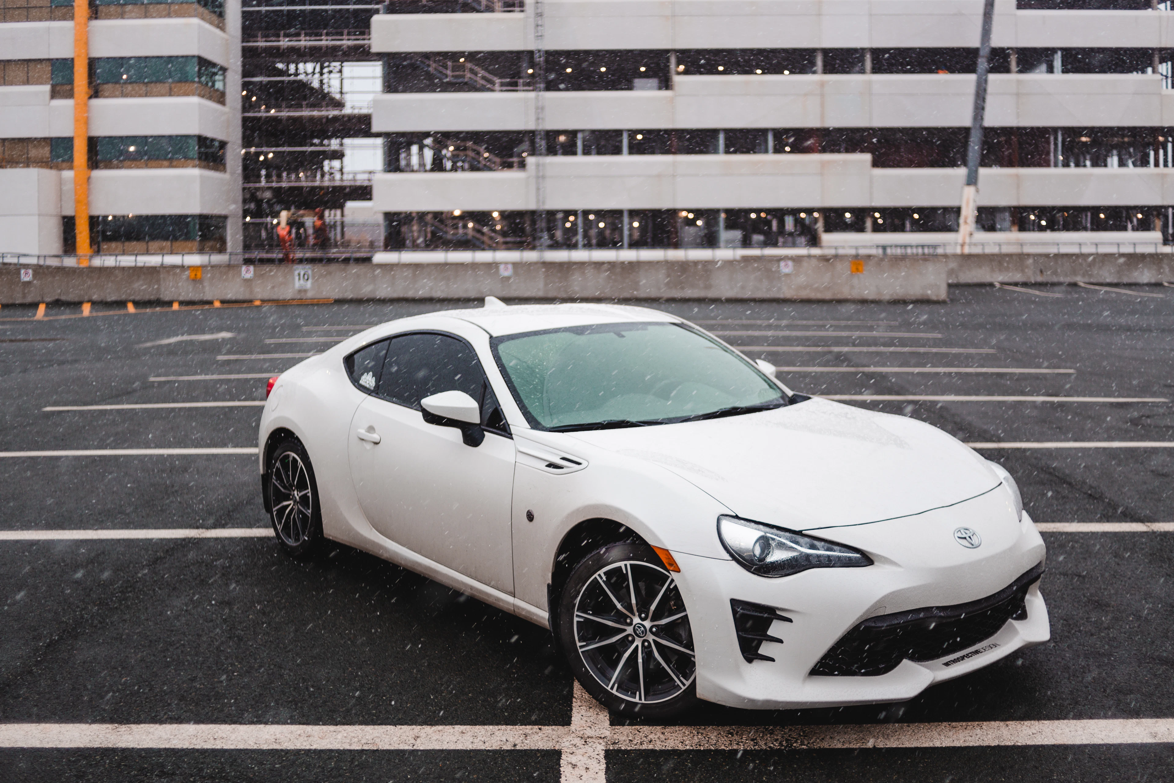 White sports coupe in a parking lot