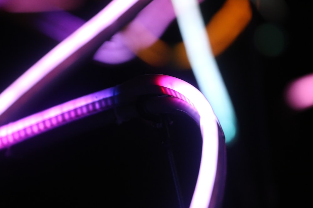 a close up of a neon light on a black background