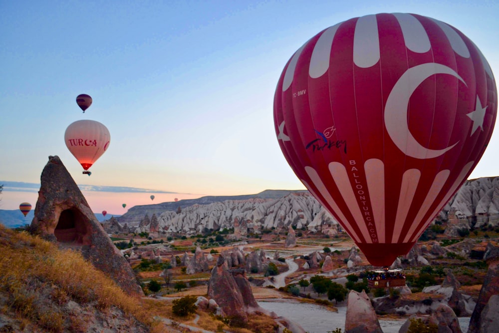 hot air balloons above mountains