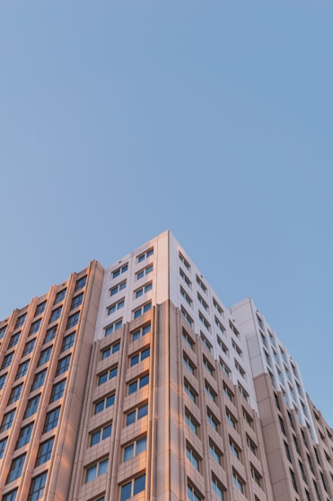 brown concrete building under blue sky