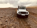 A rugged 4x4 vehicle navigating a rocky terrain.