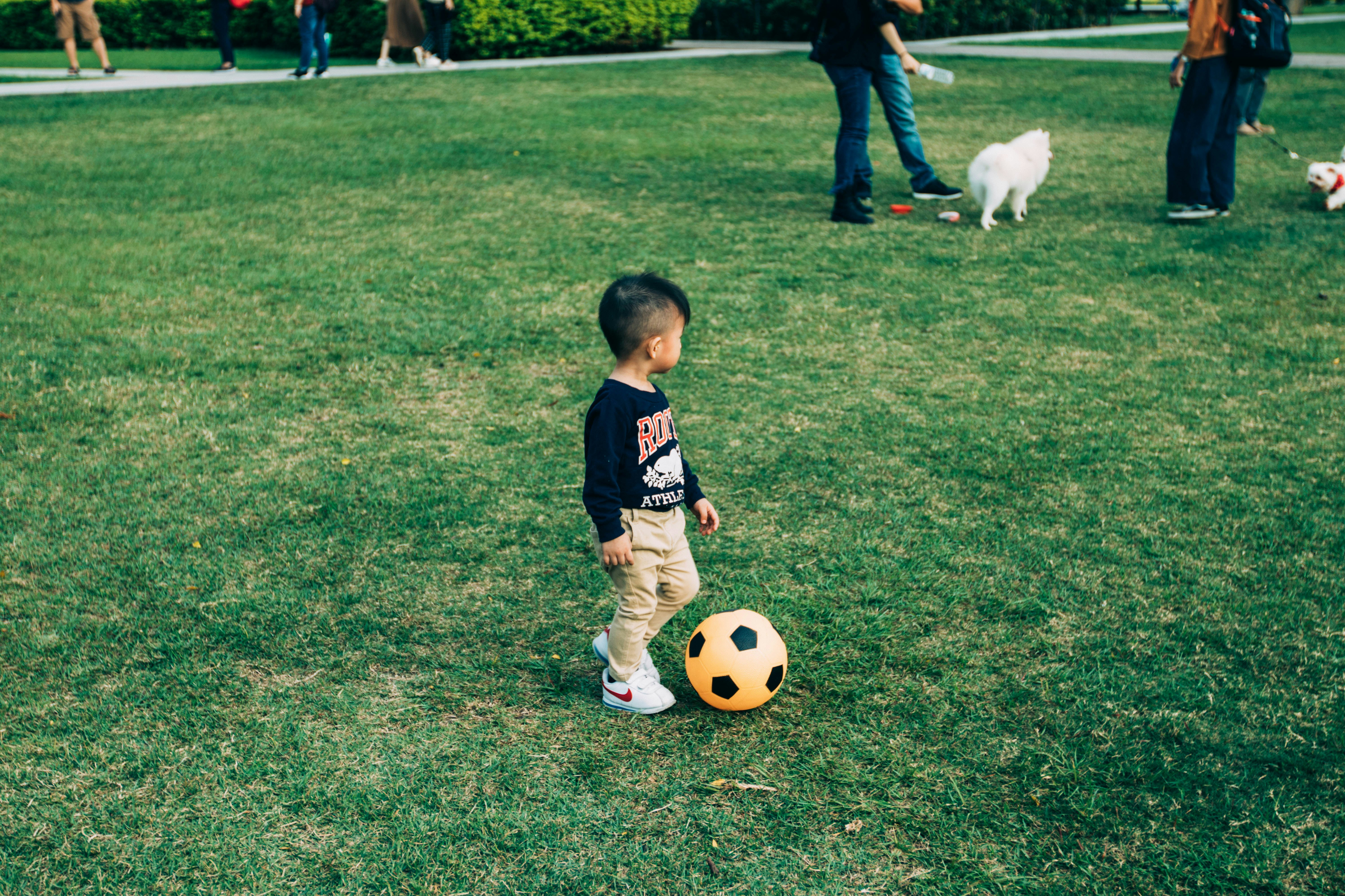 child playing football with his dad