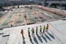 seven construction workers standing on white field