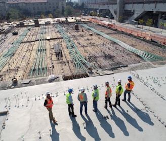 seven construction workers standing on white field