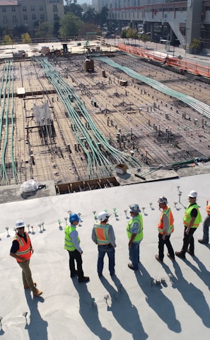 seven construction workers standing on white field