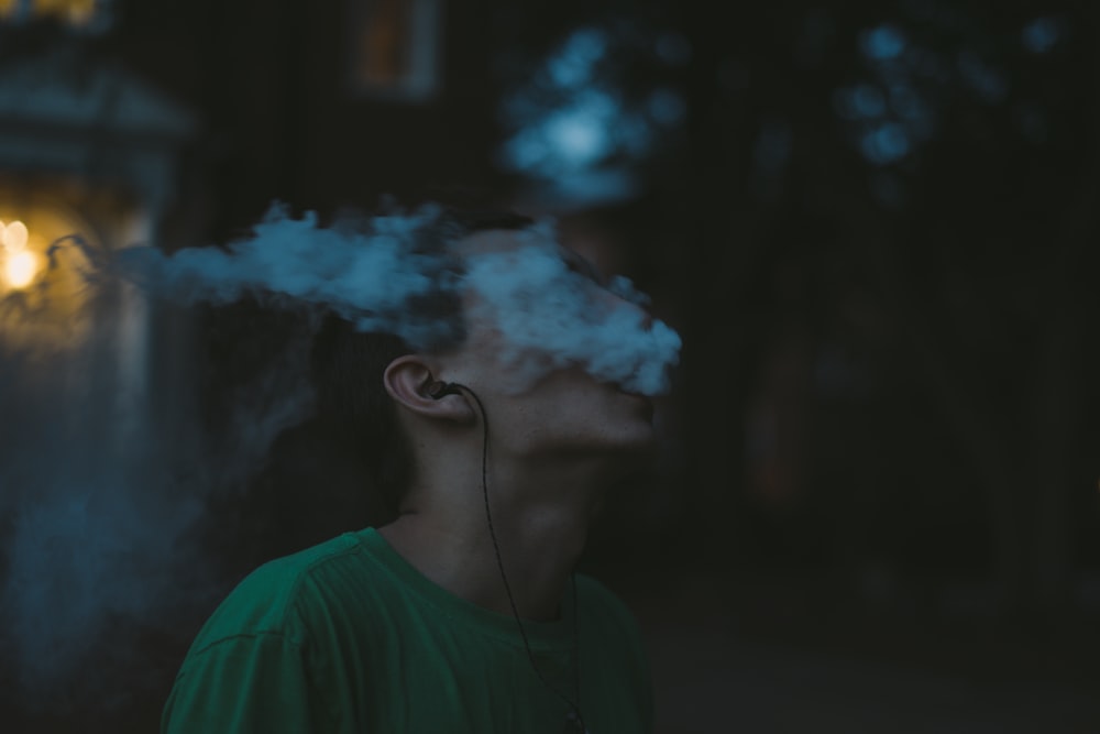 man smoking under tree