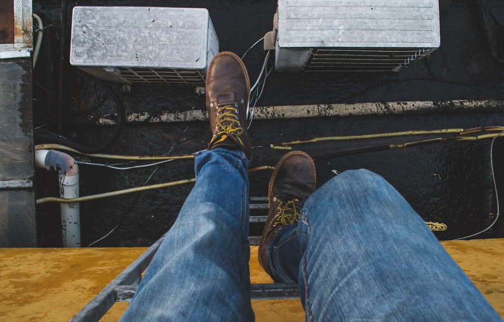 person climbing down on ladder