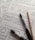 Several sheets of paper feature sketch-style website wireframes drawn with black marker lines. Two black markers and a wooden pencil rest on top of the papers, giving the scene a creative and informal touch.