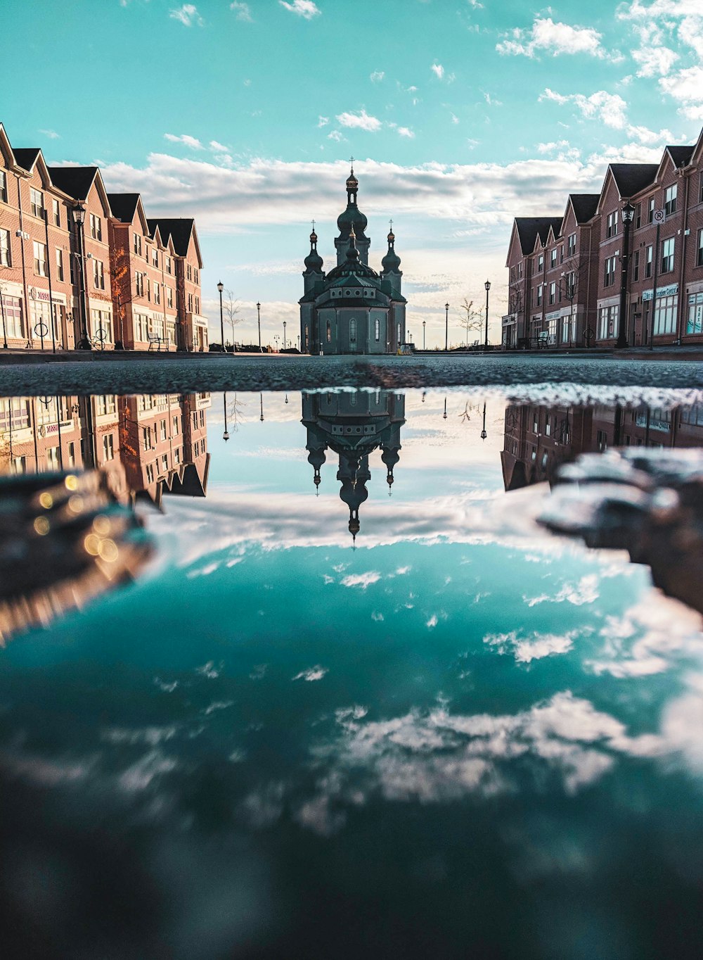 gray buildings across calm body of water