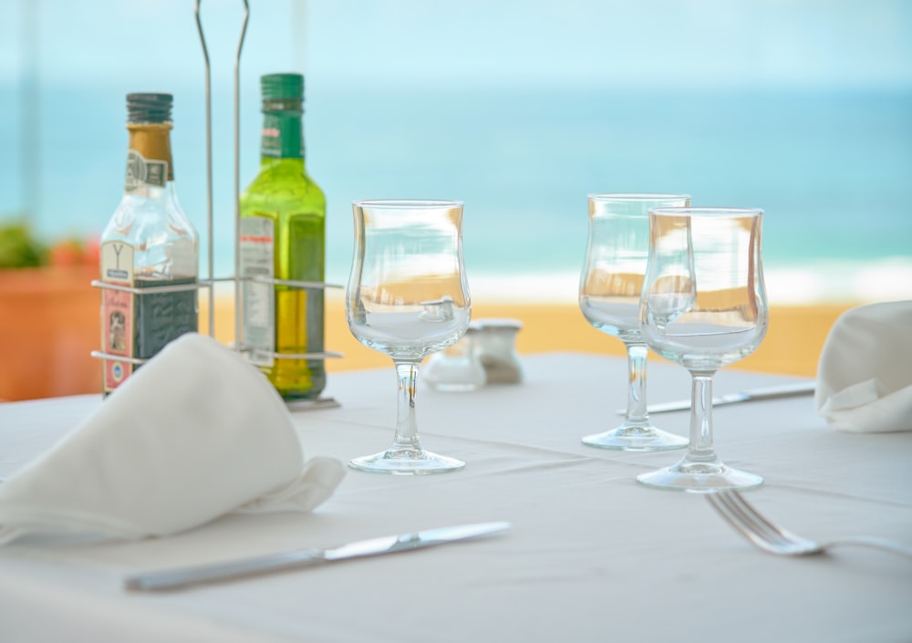 three clear wine glasses on table