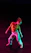 A vibrant photo of a young dancer mid-move, smiling confidently in a stylish dance studio setting with neon lights.