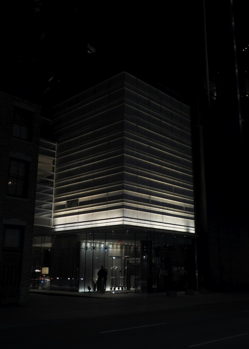person standing under building at night