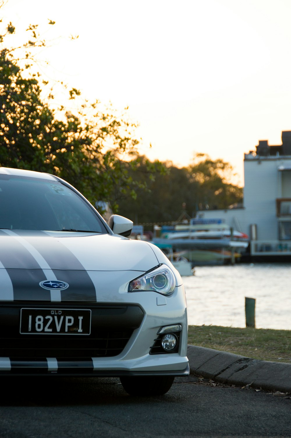 white Subaru BRZ parked near river