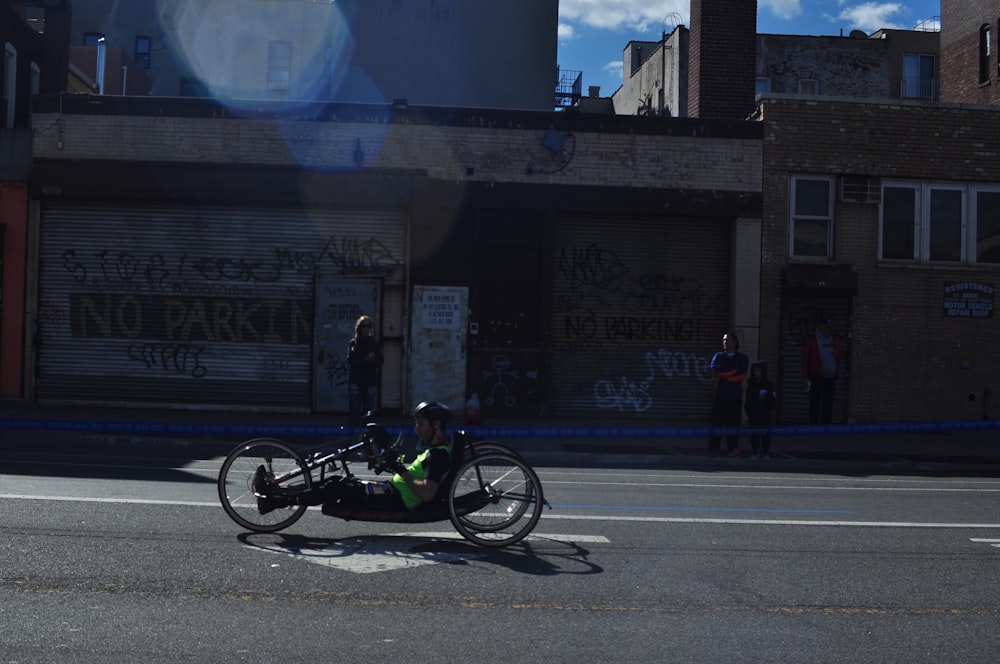 man riding trike on road