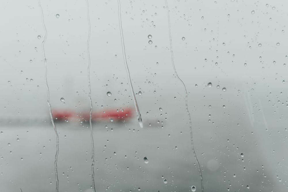 a view of a plane through a rain covered window