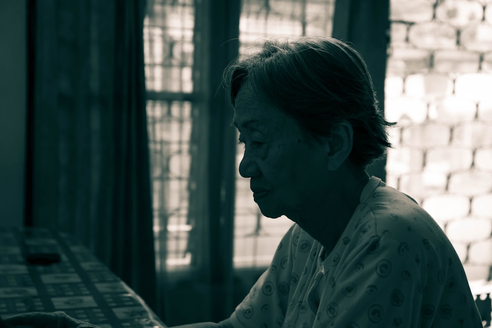 woman sitting behind table inside room