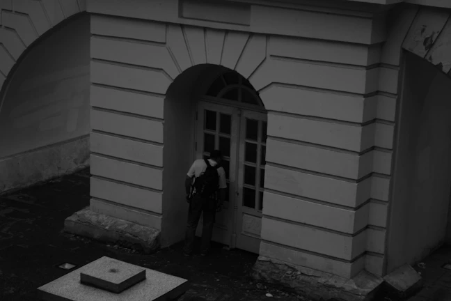 Technician inspecting a door with visible gaps due to faulty installation.