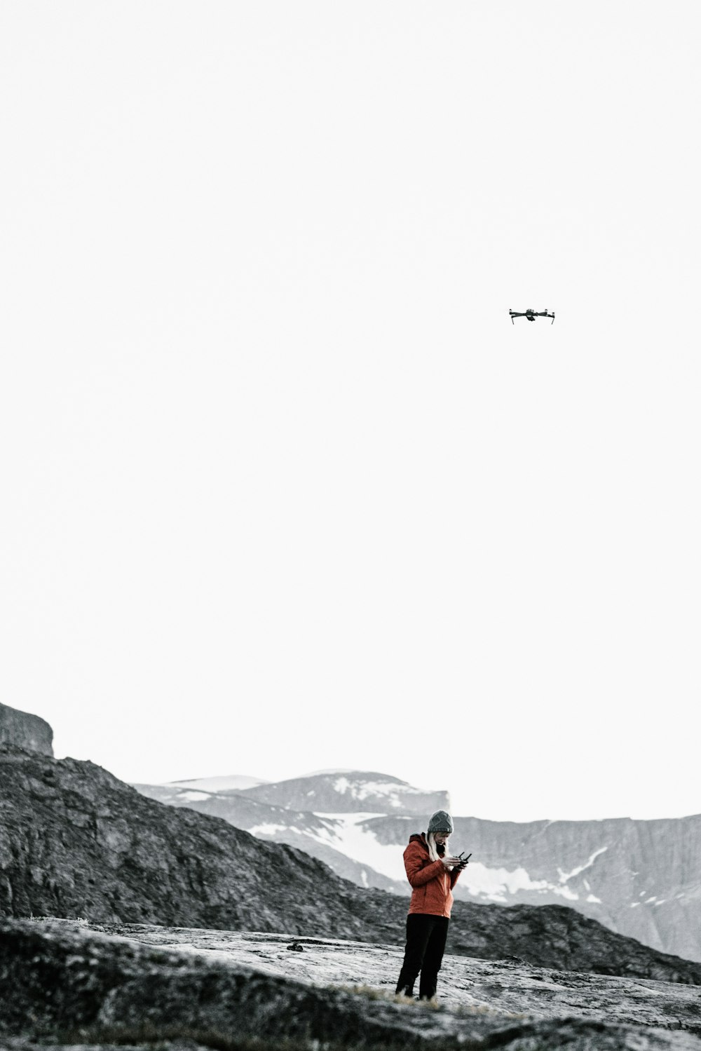 person standing in mountain under plane during daytime