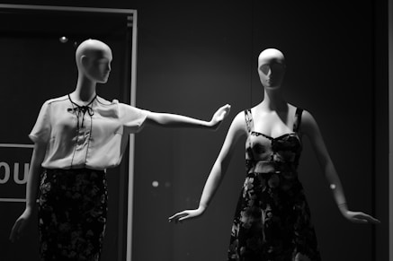 female dress form with white and black outfit beside female dress form in room