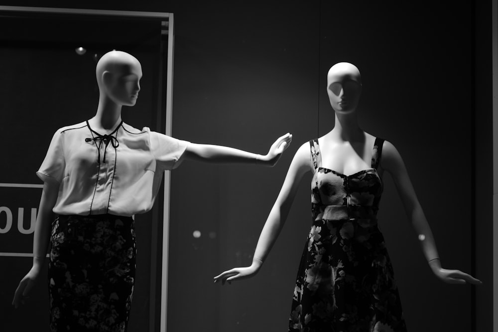 female dress form with white and black outfit beside female dress form in room