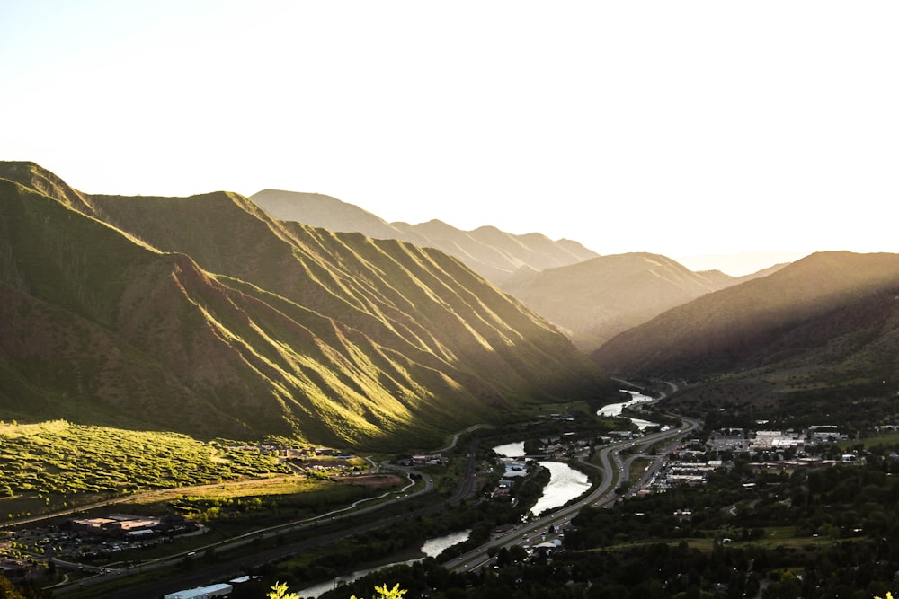 aerial photography of houses in between mountains during daytime