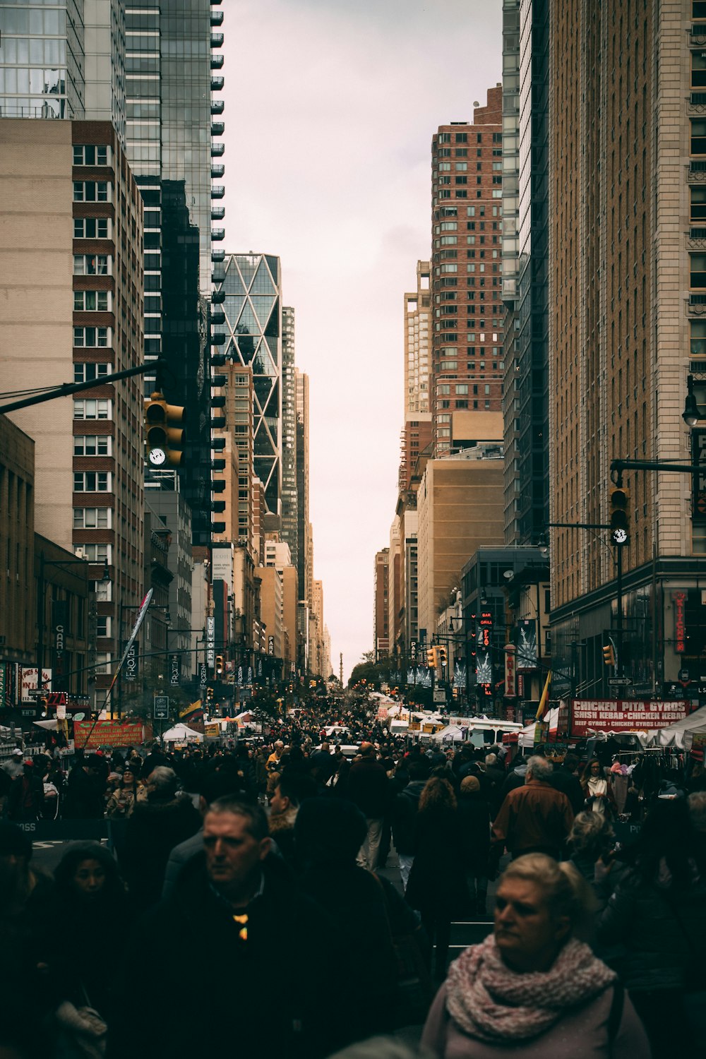 people on road between high-rise buildings