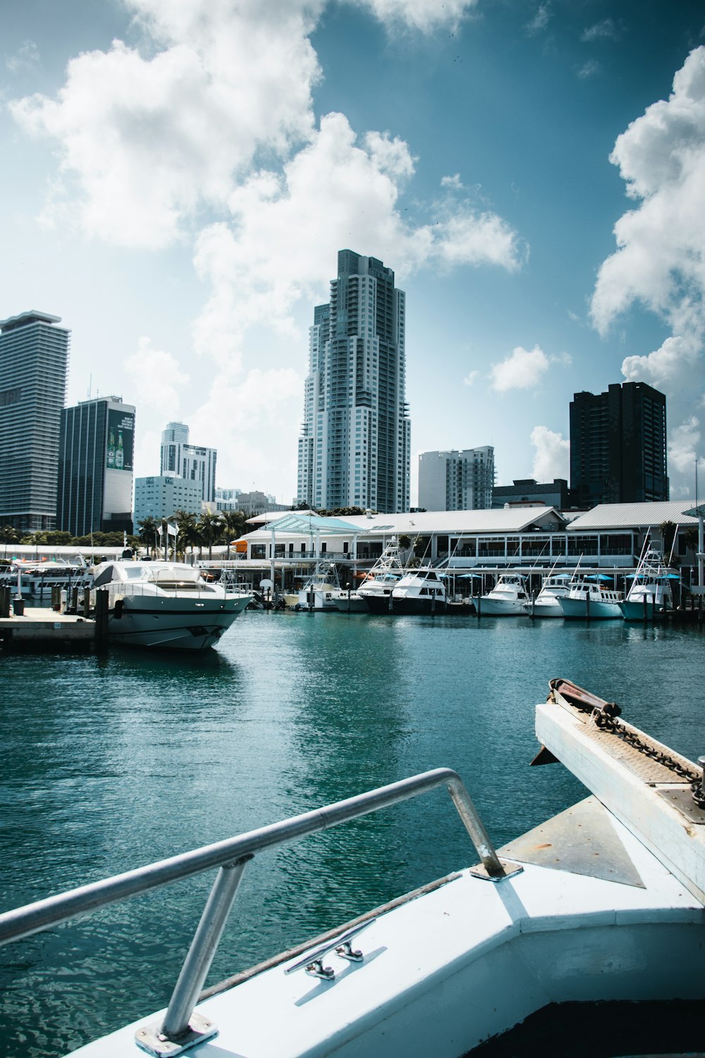 white yachts near high-rise building